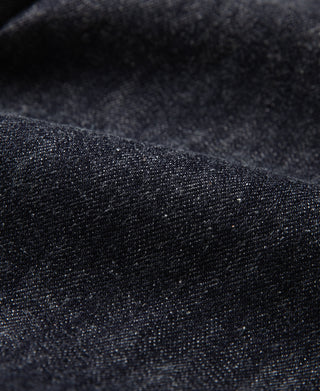 Indigo selvedge denim jacket fabric close-up, textured weave detail