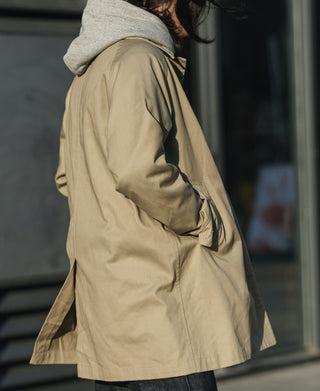 Khaki all-weather trench coat side view, belted waist and long sleeves