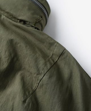 Olive M-65 parka with zipper opening and stitched side panel