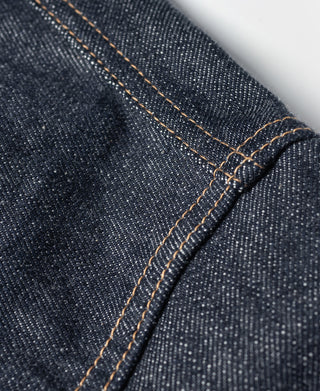 Indigo denim jacket side seam with contrast tan topstitching