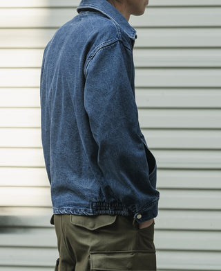 Indigo stonewashed denim zip-up jacket with turn-up cuffs and side pockets
