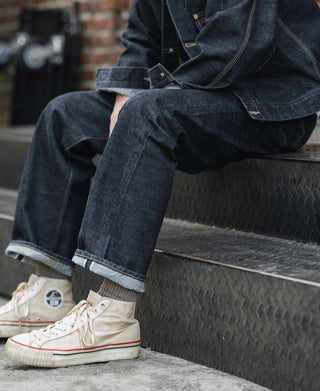 Indigo denim jeans with cuffed hem and contrast topstitching on the leg opening