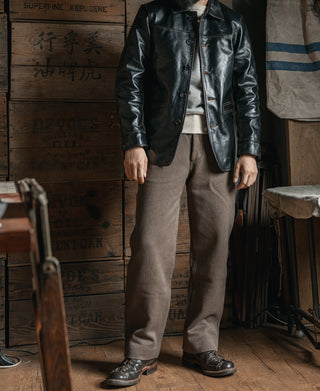 Brown textured stripe pants styled with a dark jacket and dark leather shoes