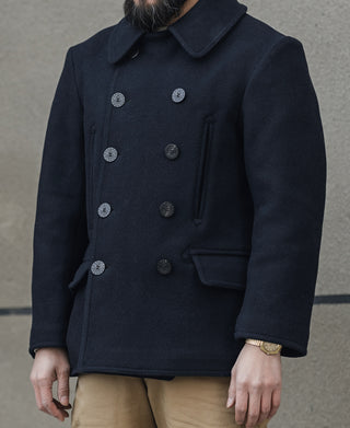 Men's navy peacoat front view with double-breasted buttons and side pocket
