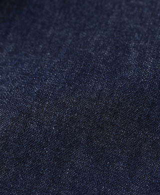 Indigo selvage denim jeans fabric close-up with fine textured weave