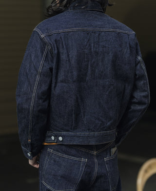 Indigo denim jacket back with yoke stitching and front pocket flap with snaps