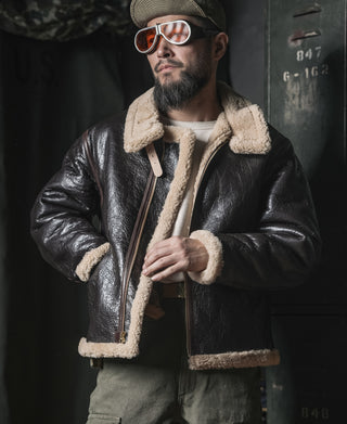 Dark brown leather flight jacket with cream shearling collar, zip front, and pocket