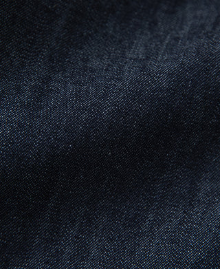 Indigo denim fabric close-up with fine textured weave