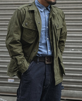 Olive military-style fatigue jacket with flap chest pockets and button front