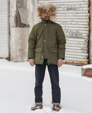 Olive down parka with faux-fur trimmed hood, front zipper, and two chest pockets