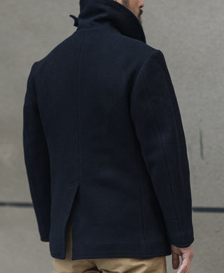 Men's navy peacoat back view with center seam and rear vent