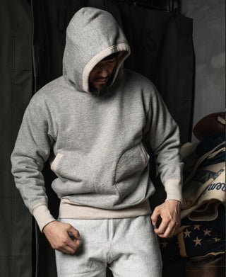 Gray hooded hoodie with boxing glove pocket and ribbed cuffs, front pouch pocket visible.