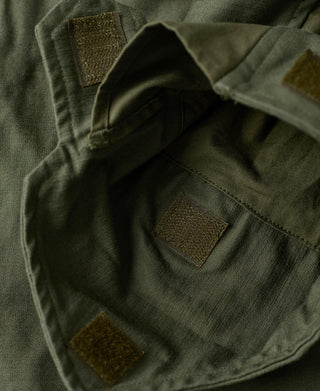 Olive field jacket inner pocket with dark canvas patch inserts