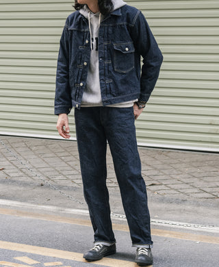 Indigo denim jacket on person, front button closure with two chest flap pockets.