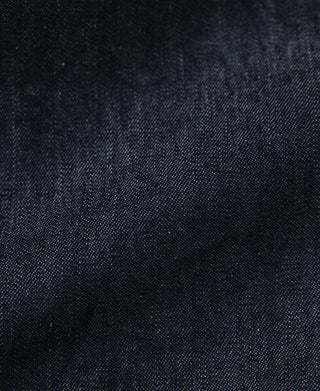 Indigo denim jacket fabric texture close-up, dark indigo with fine weave detail
