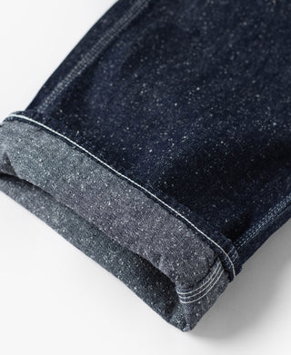 Indigo denim carpenter pants cuff with speckled slub texture and neat edge stitching
