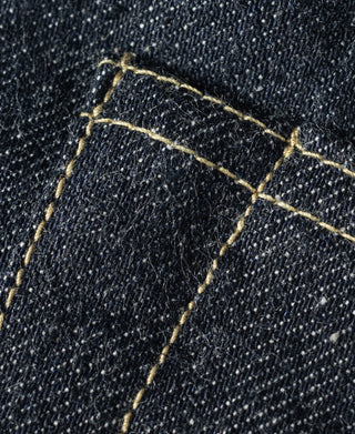 Indigo selvedge denim jeans, close-up of selvage stitching lines on dark denim