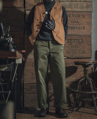 Khaki canvas hunting vest worn by a model, multiple pockets and button front