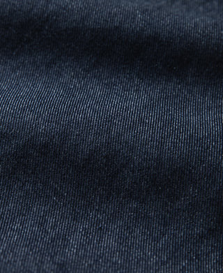 Indigo denim jacket fabric texture close-up with fine twill weave