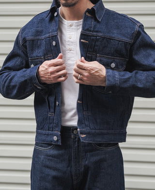 Indigo denim jacket with button front and chest pockets over a white T-shirt