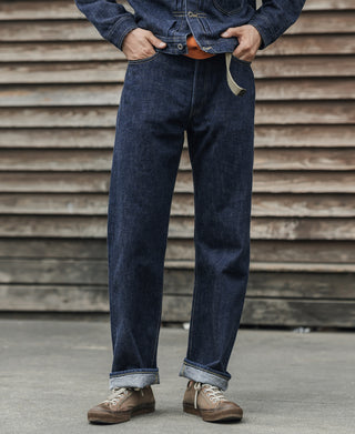 Indigo denim jeans on model with straight fit and cuffs, front view