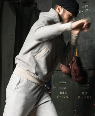 Gray boxing glove pocket lock hood hoodie with full-zip-style silhouette, ribbed cuffs.