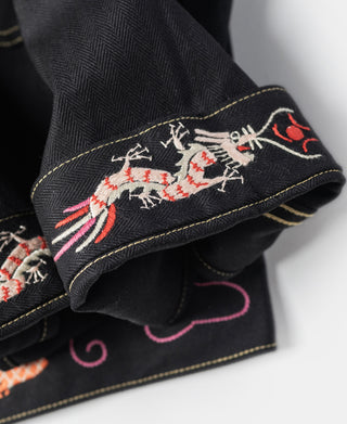Black tour jacket cuff with multicolor embroidered dragon and pink swirls