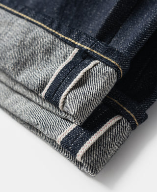 Folded hem and cuff with contrast light stitching on dark denim jeans