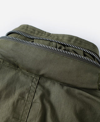 Olive M-65 parka with front zipper and ribbed trim at hood