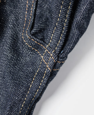 Indigo denim jacket cuff seam with tan contrast stitching