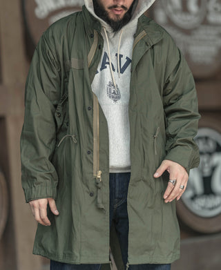 Olive green M-65 style parka with snap pockets and hooded collar
