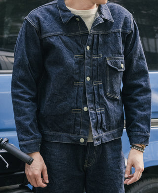 Indigo denim jacket on person, front buttoned with chest pockets and yoke.