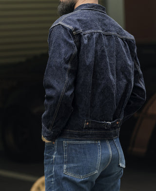 Indigo selvedge denim jacket back view, yoke seam and buttoned collar