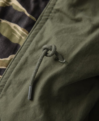 Olive drawstring cord on camo M-65 jacket hem