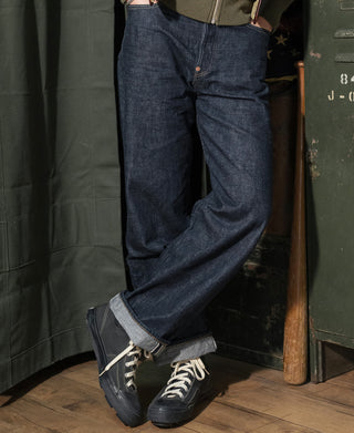 Indigo denim jeans side view with cuffed hem and visible seam stitching