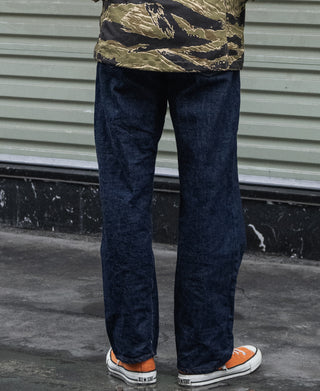 Dark blue denim jeans on model, straight fit with cuffed hems
