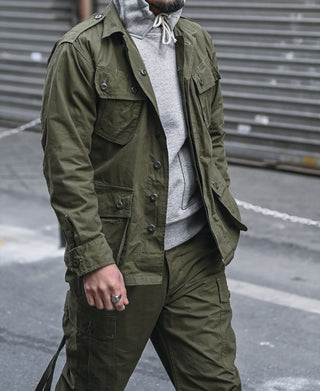 Olive fatigue jacket with button front and flap utility pockets