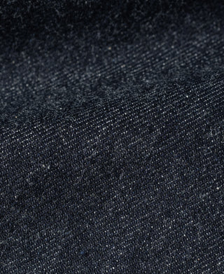 Indigo selvedge denim fabric close-up with fine white flecks