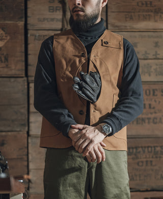 Khaki canvas hunting vest with two flap chest pockets and dark buttons