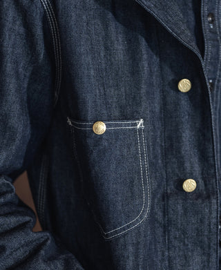 Indigo denim jacket chest pocket with gold snaps and contrast topstitching