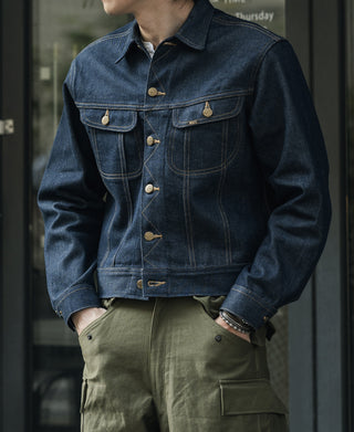 Indigo denim jacket with button front, flap chest pockets, and gold-tone buttons
