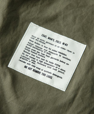 Care label on olive lining inside M-65 field jacket