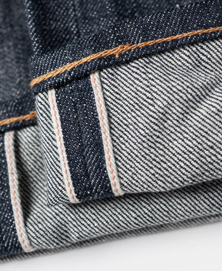 Indigo denim pocket with off-white lining and red stripe seam detail