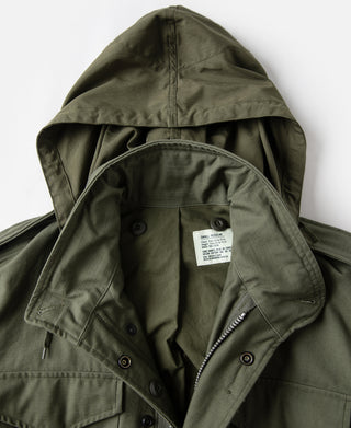 Olive field jacket hood with interior size label and snap buttons