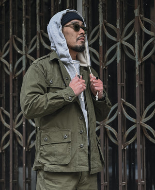 Olive fatigue jacket with snap-flap pockets and button front