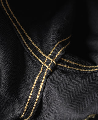 Black tour jacket neckline with contrast gold piping and stitched cross design