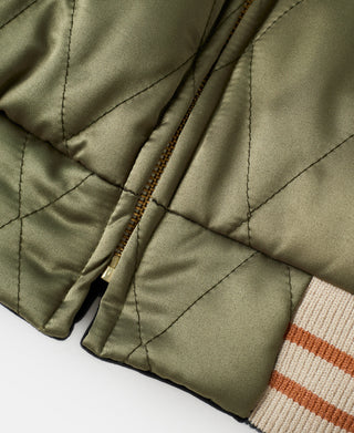 Olive quilted jacket with metal zipper, diagonal quilting, and rib knit cuff