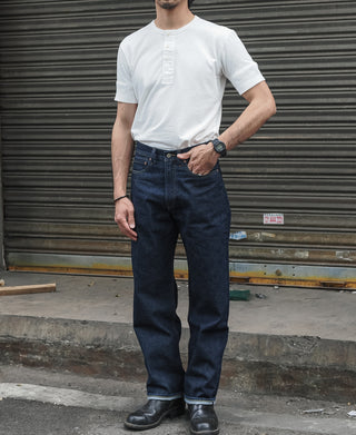 Indigo selvedge denim jeans on model, straight fit with dark wash