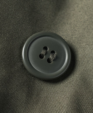 Olive flight jacket round front button with fabric loop detail.
