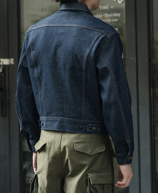 Indigo denim jacket back with raised collar and contrast tan panel stitching